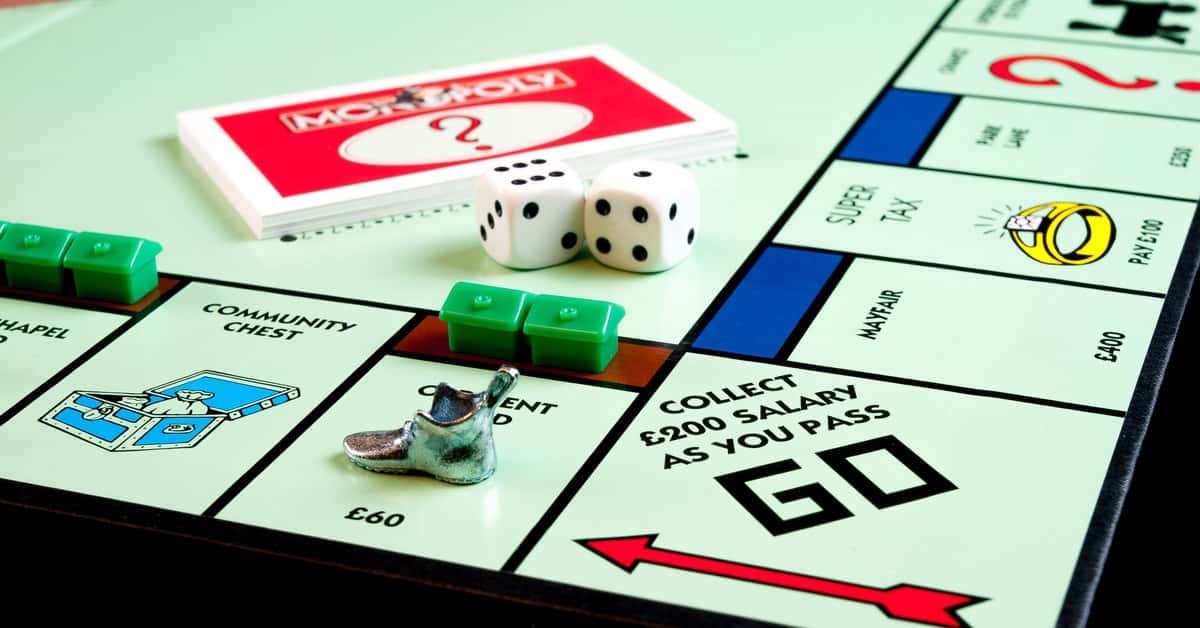 Detailed view of Monopoly board game pieces, dice, and properties.