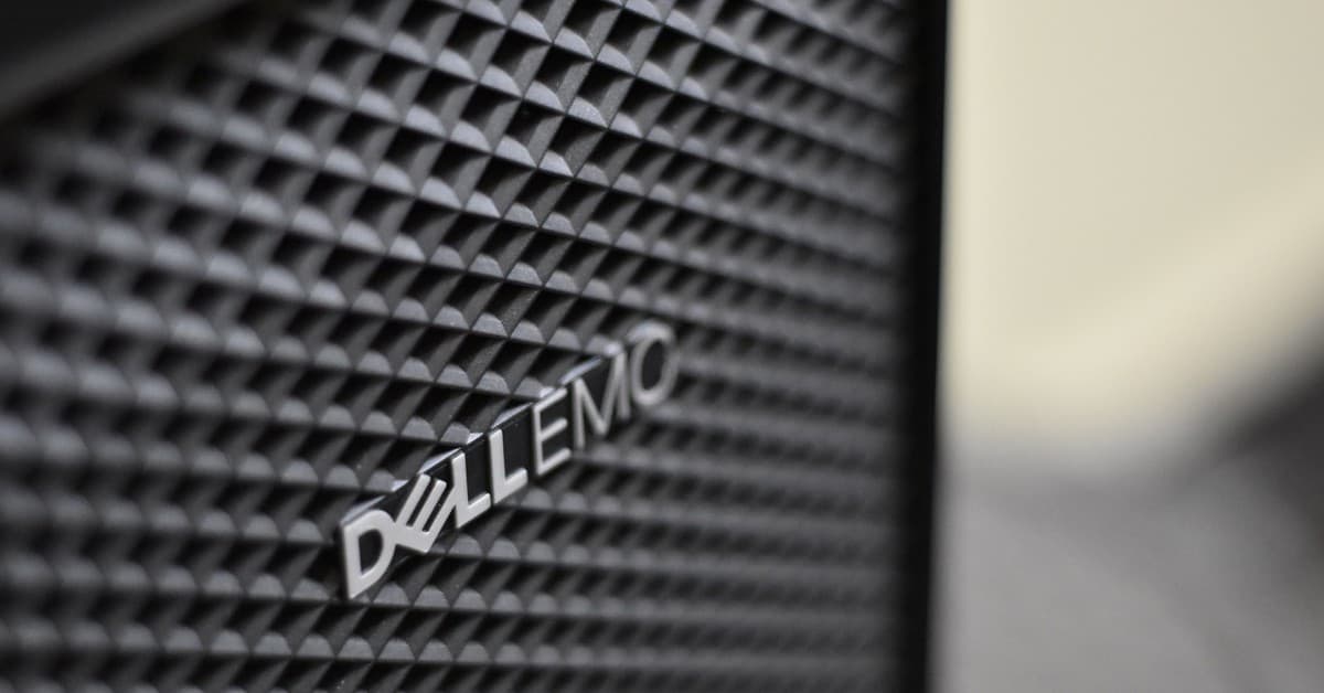 Detailed close-up of Dell EMC server logo on hardware grill with shallow focus and textured patterns.