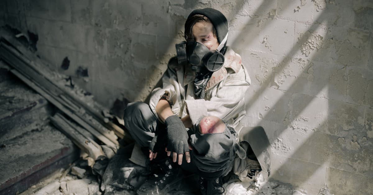 A young person in a gas mask sits in a decaying, abandoned building, evoking themes of survival and desolation.