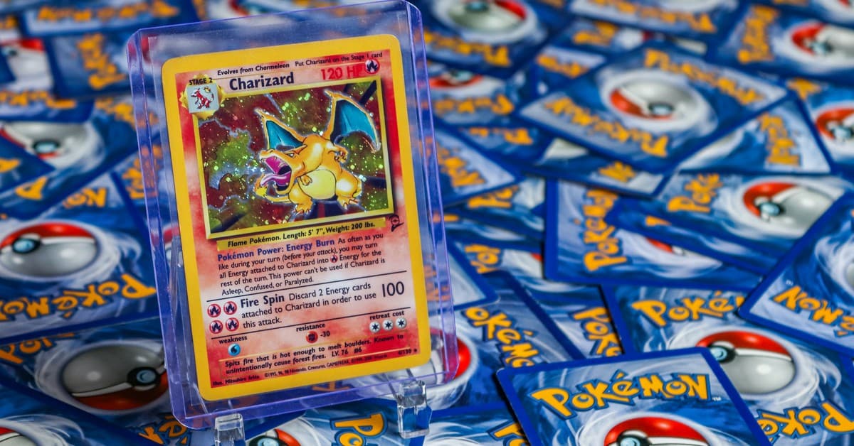 High-value Charizard Pokémon trading card surrounded by various other cards.