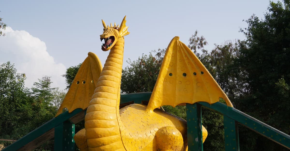 A colorful dragon sculpture situated in a scenic park in Panchkula, India.