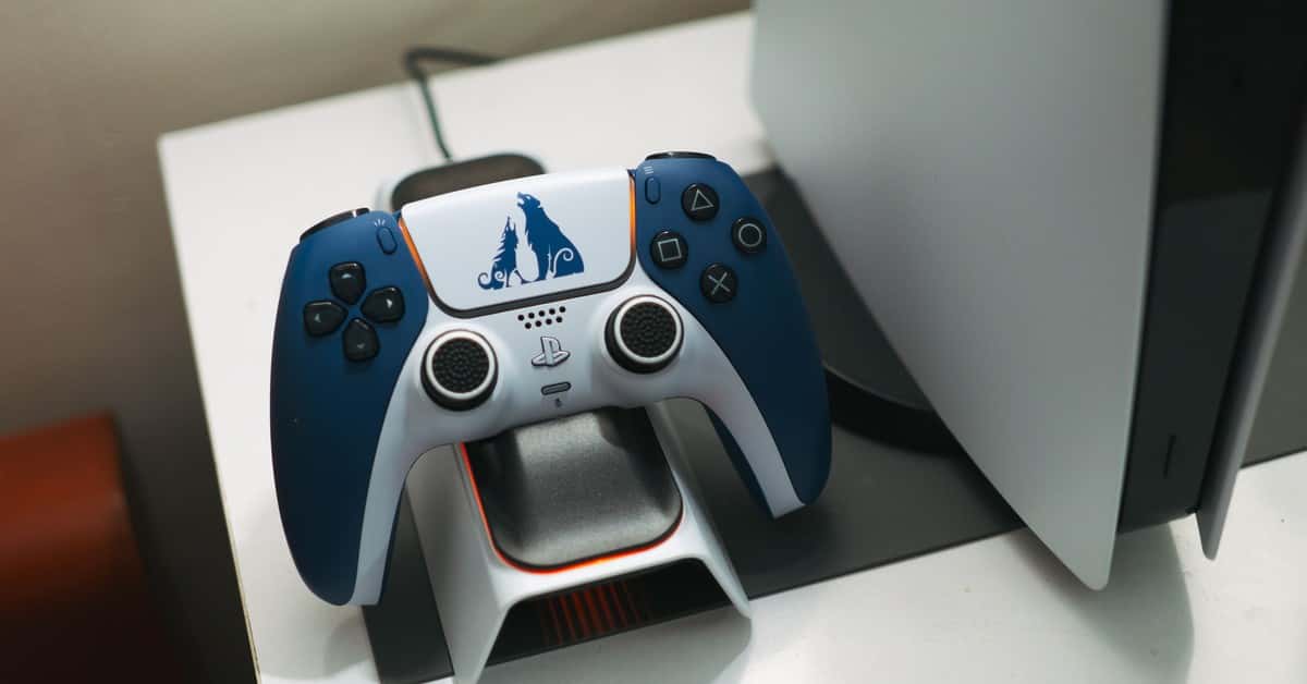 Close-up of a DualSense controller charging on a dock, perfect for gaming setups.