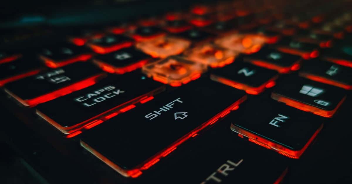 Detailed view of an RGB backlit gaming keyboard with glowing red keys.