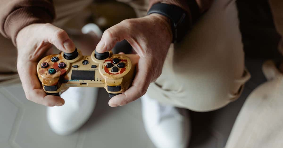 A person playing video games with a vintage-style controller indoors.