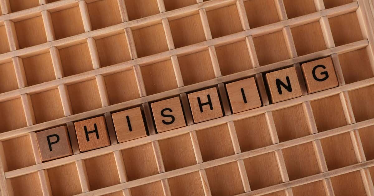 Wooden Scrabble tiles arranged to spell 'Phishing', illustrating online security concepts.