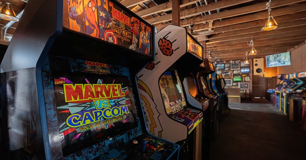 Modern arcade machines with bright luminous monitors and inscriptions in contemporary public entertainment center