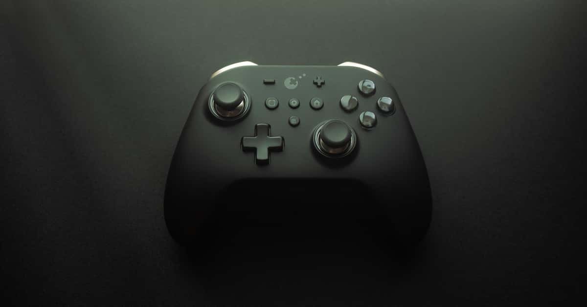 High-quality image of a modern game controller on a smooth black surface, highlighting design and technology.