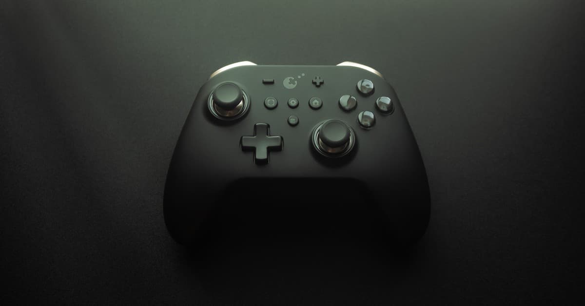 High-quality image of a modern game controller on a smooth black surface, highlighting design and technology.