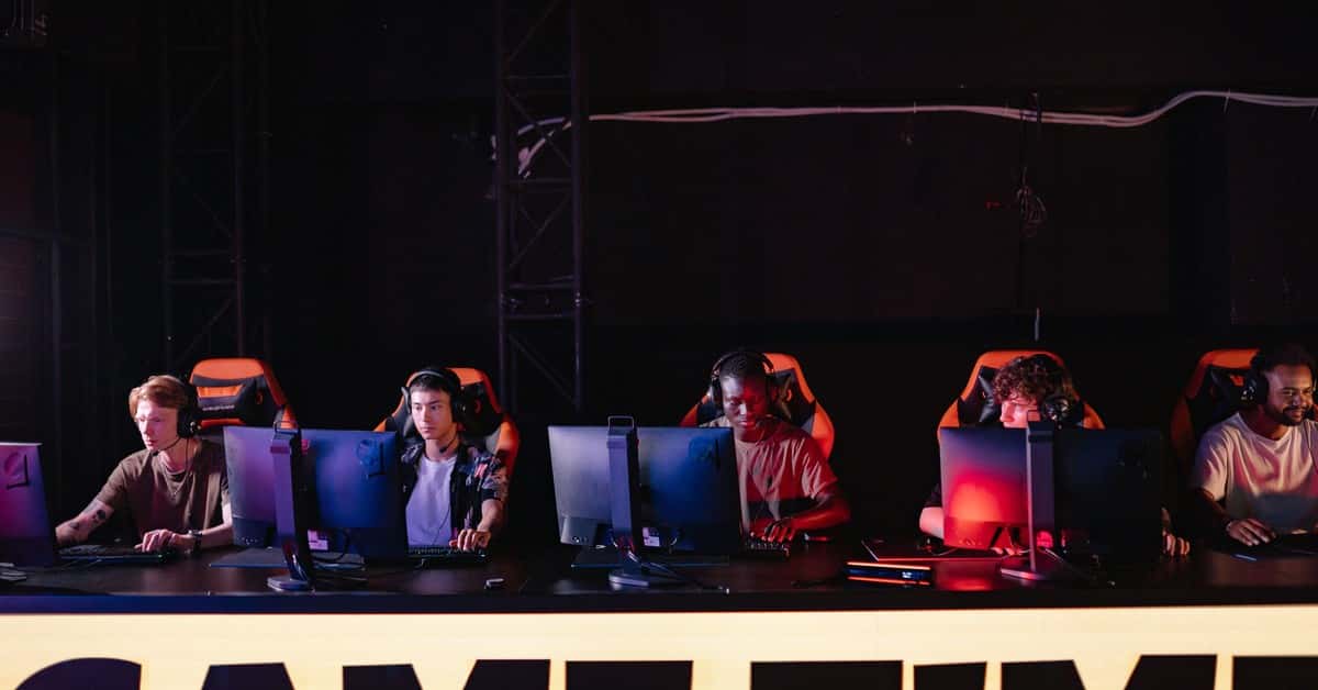 A group of diverse gamers participating in an online eSports tournament indoors.