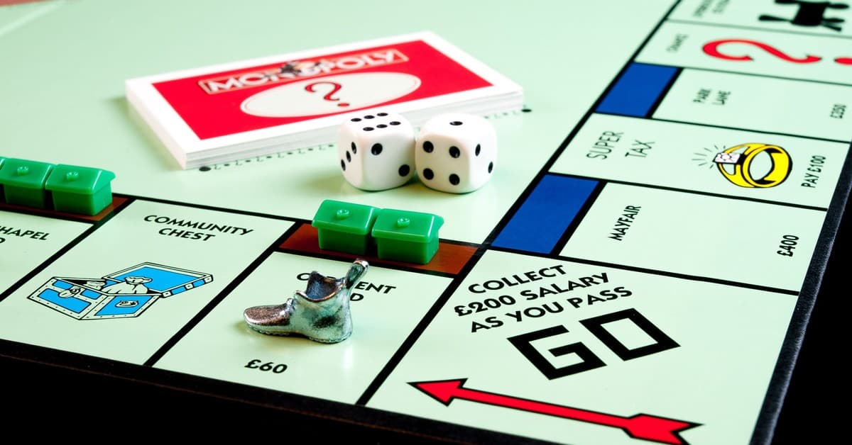 Detailed view of Monopoly board game pieces, dice, and properties.