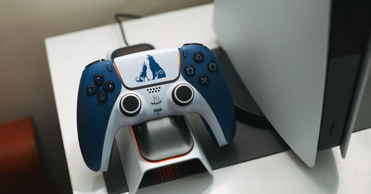 Close-up of a DualSense controller charging on a dock, perfect for gaming setups.