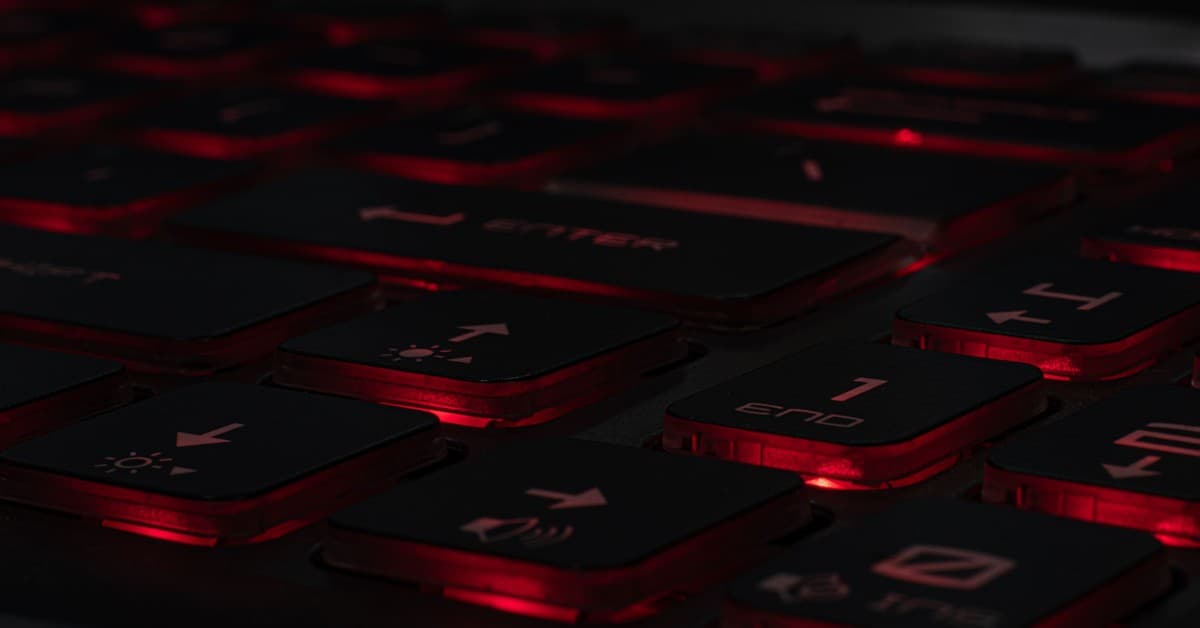 Detailed view of a backlit gaming keyboard with red LED lighting and black keys.