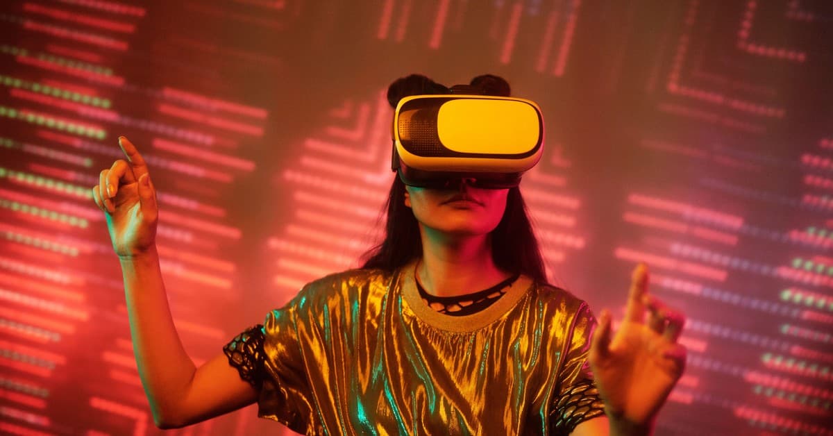Woman in a metallic top using a virtual reality headset immersed in a digital environment with vibrant lights.