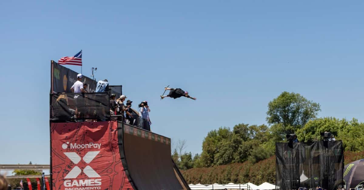 Exciting skateboard stunt at X Games 2026 in Sacramento, captured mid-air with crowd spectators.