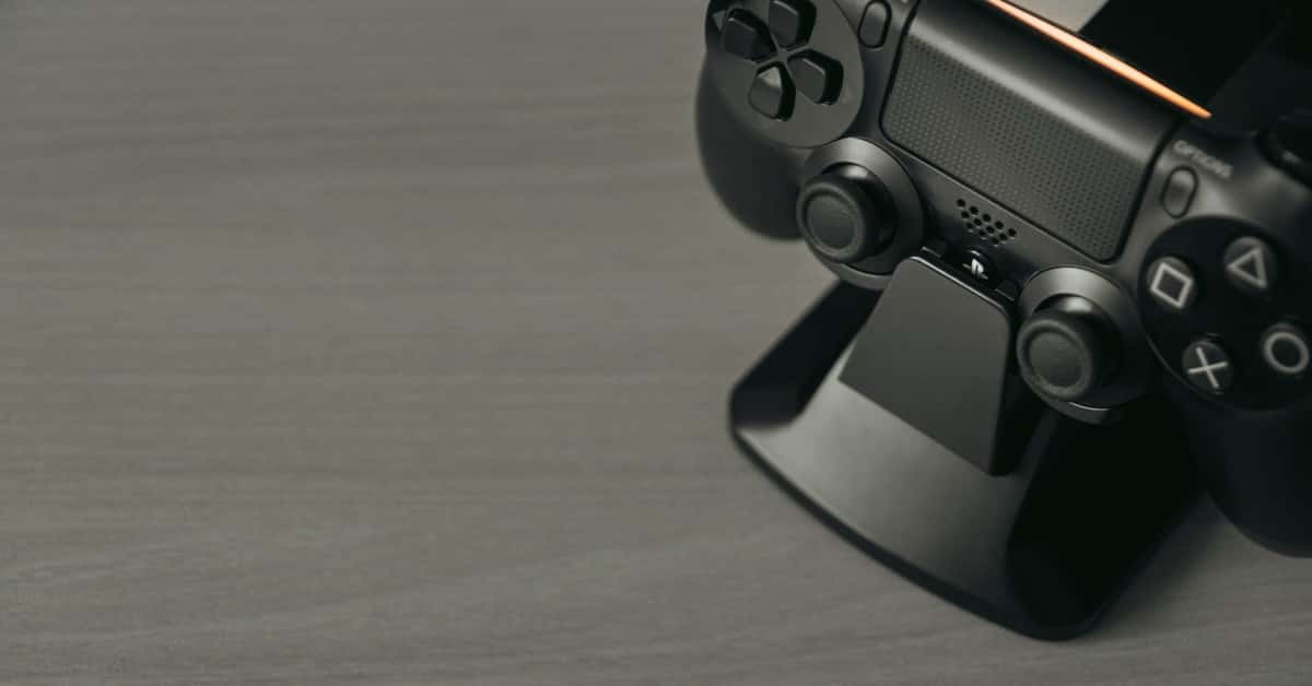 Black PS4 controller on display stand with copy space
