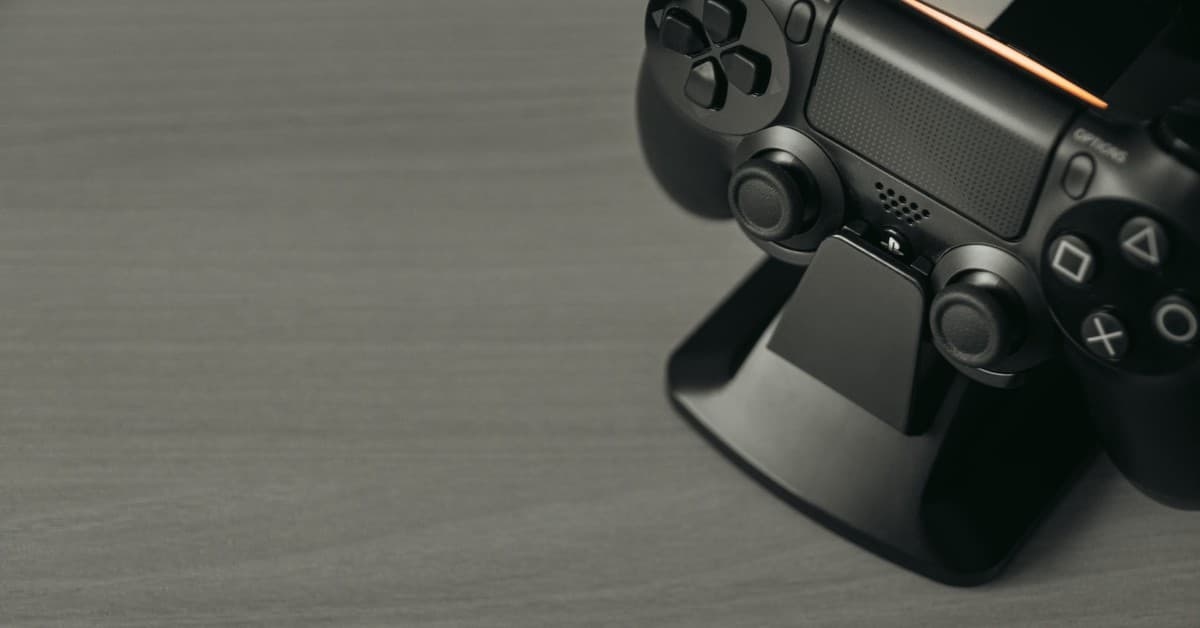 Black PS4 controller on display stand with copy space