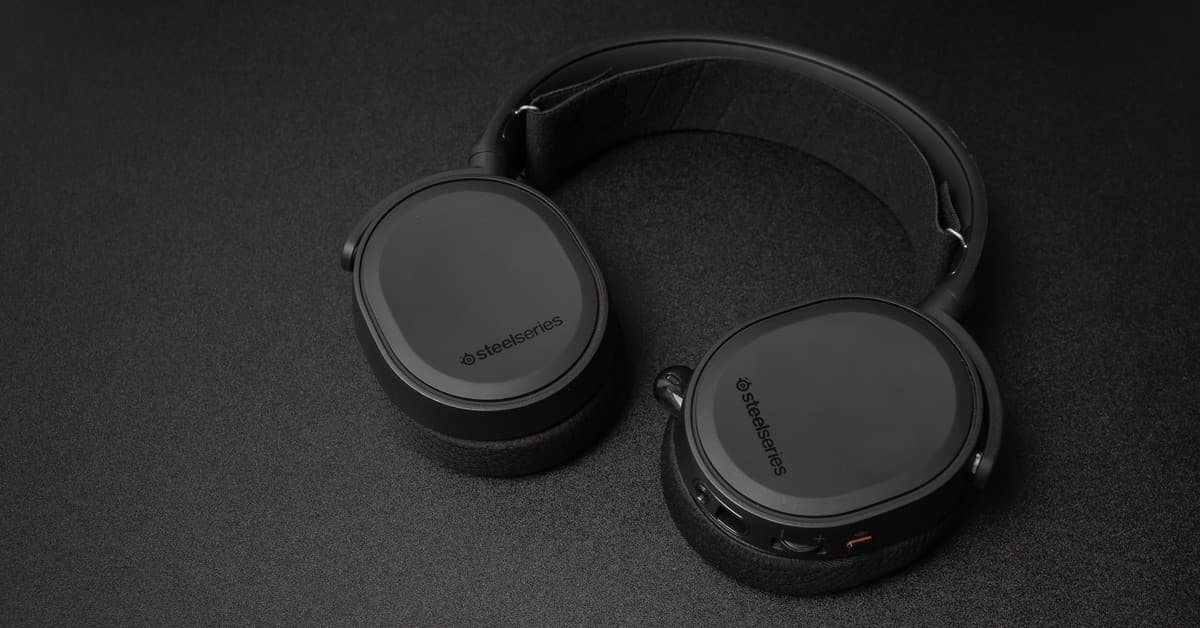 Close-up of SteelSeries headphones on a black surface. Minimalist and sleek.