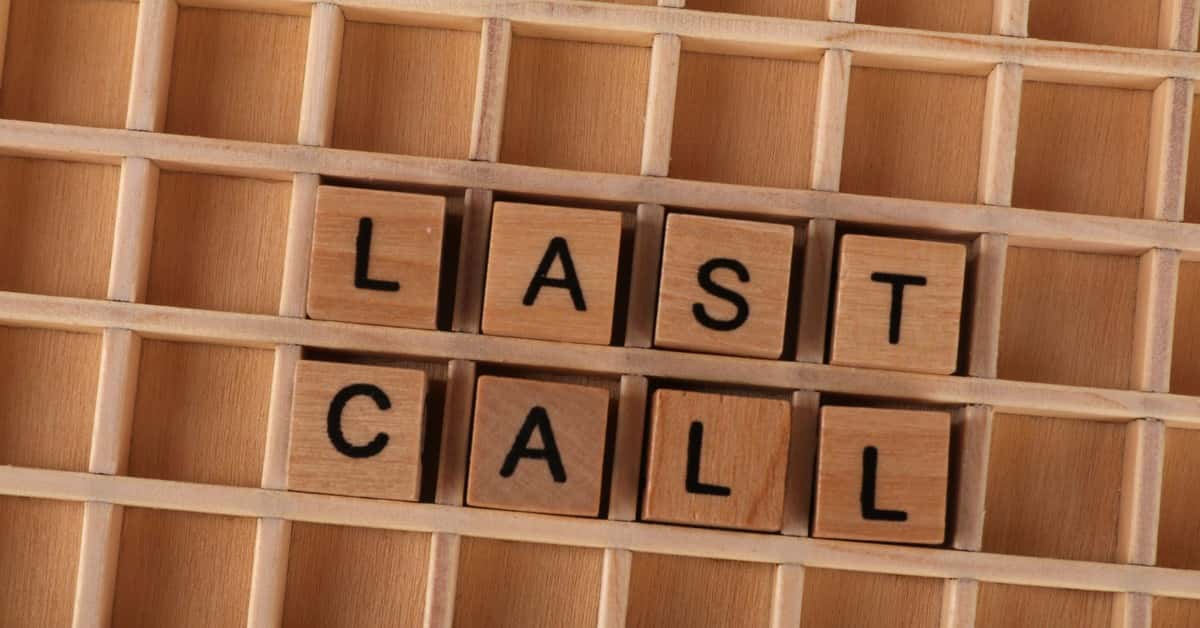 Wooden letter tiles forming the phrase 'Last Call' on a wooden background.