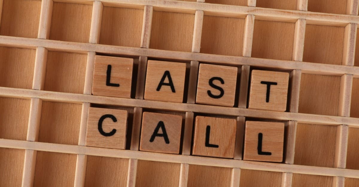 Wooden letter tiles forming the phrase 'Last Call' on a wooden background.