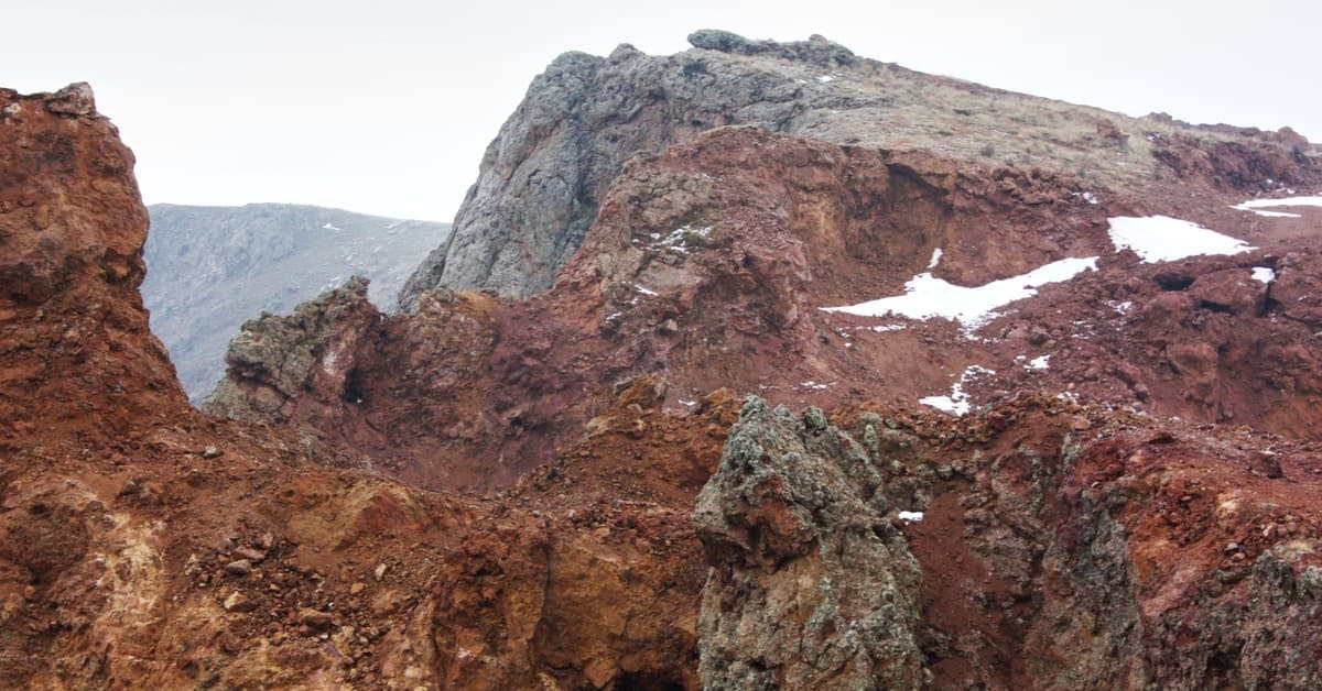 Explore the dramatic rocky landscape of Divriği with rich red hues and rugged textures.