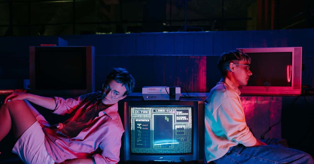 Teenagers enjoying retro gaming on vintage screens with neon lights. Nostalgic 80s vibe.