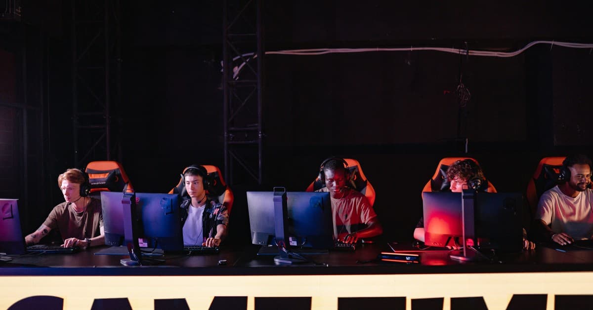 A group of diverse gamers participating in an online eSports tournament indoors.