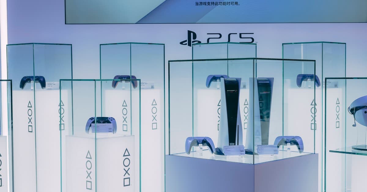 PlayStation 5 consoles and accessories on display in a sleek, futuristic showroom.